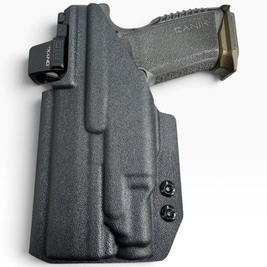 A black textured polymer holster containing a semi-automatic handgun, shown from a top-down angle on a white background. The holster features a mounted black accessory on the left side with the brand name 'ONX'.