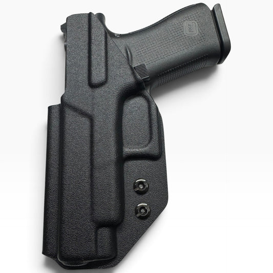 A black textured polymer or leather holster containing a handgun, photographed on a clean white background.