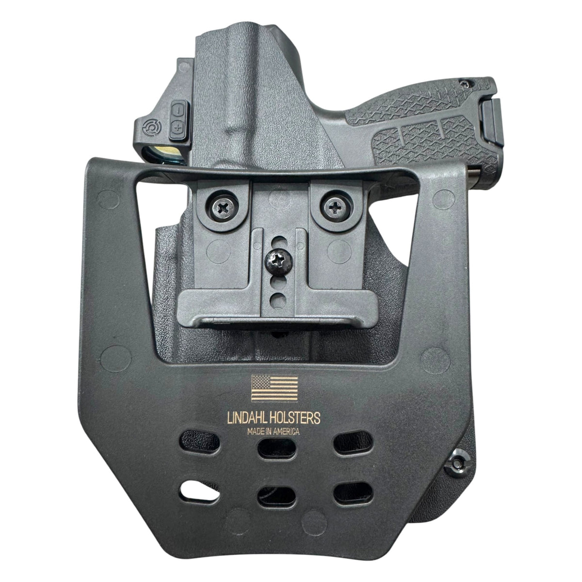 A black tactical holster with a mounted quick-release clip and a handgun partially inserted, photographed on a plain white background. The holster is branded with 'LINDAHL HOLSTERS' and 'MADE IN AMERICA' printed on the front.