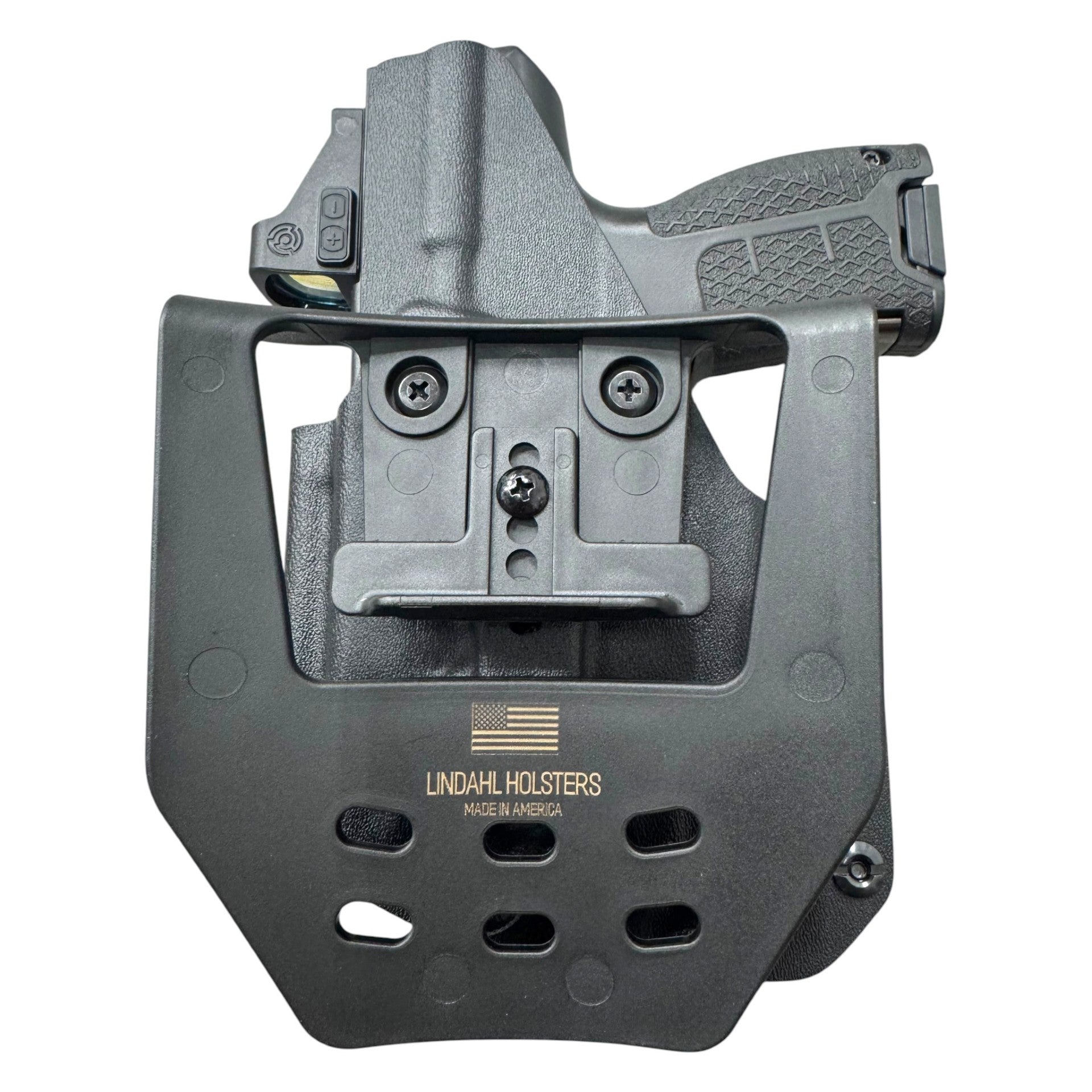 A black tactical holster with a mounted quick-release clip and a handgun partially inserted, photographed on a plain white background. The holster is branded with 'LINDAHL HOLSTERS' and 'MADE IN AMERICA' printed on the front.
