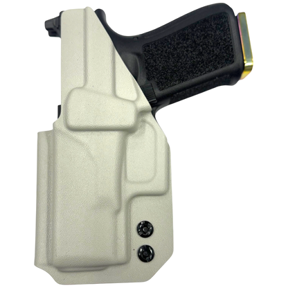 Beige gun holster with a black gun inside on a white background