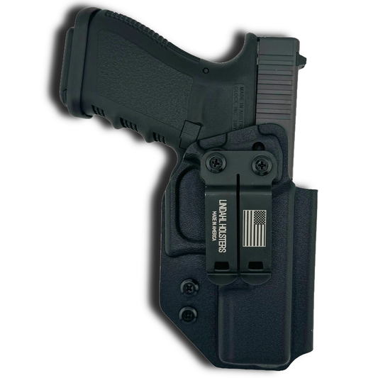 Black handgun with holster on a white background