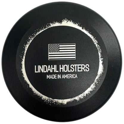 Black round object with 'Lindahl Holsters Made in America' text and American flag logo on a white background