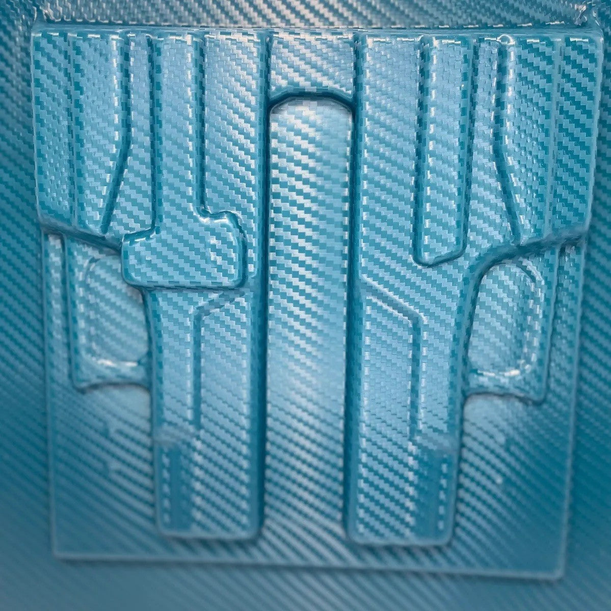 Blue textured plastic sheet with cut-out shapes on a blue background