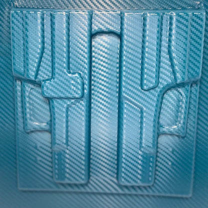 Blue textured plastic sheet with cut-out shapes on a blue background