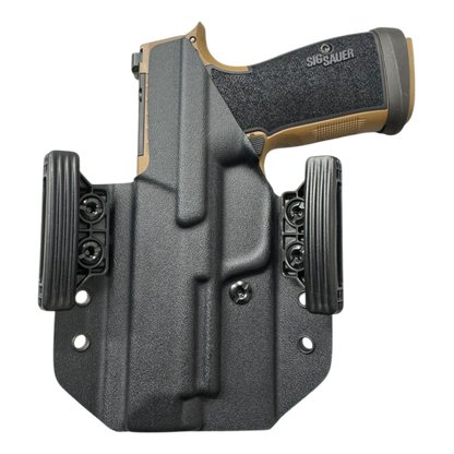 Sig Sauer handgun in a black holster on a white background