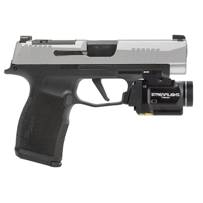 Handgun with Streamlight flashlight attachment on a white background