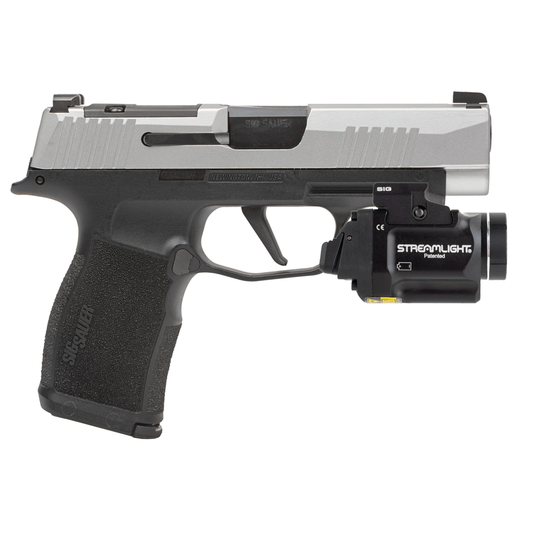 Handgun with Streamlight flashlight attachment on a white background