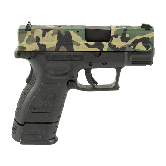 Handgun with camouflage slide on a white background